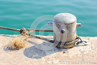 Mooring Bollard with rope Stock Photo