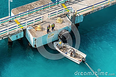 Mooring gang and motorboat with mooring lines of a Cruise ship in Ocho Rios, Jamaica Editorial Stock Photo