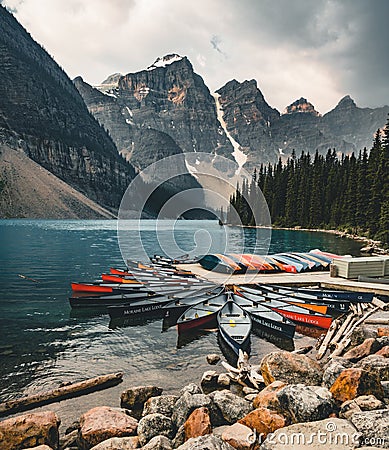 Moraine Lake and boat kayak canoe with mountains of Banff National Park in Canada Editorial Stock Photo