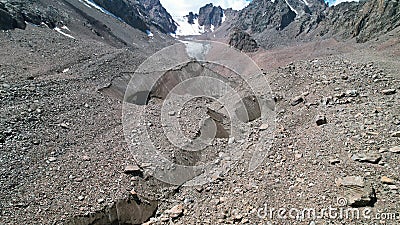 A moraine lake among a glacier covered with rocks Stock Photo