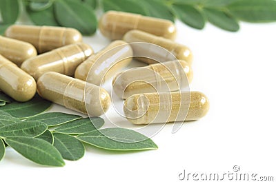 Moringa oleifera capsule with green leaves Stock Photo