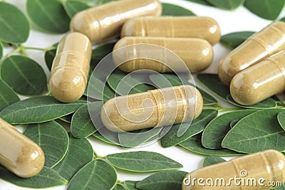 Moringa oleifera capsule with green leaves Stock Photo