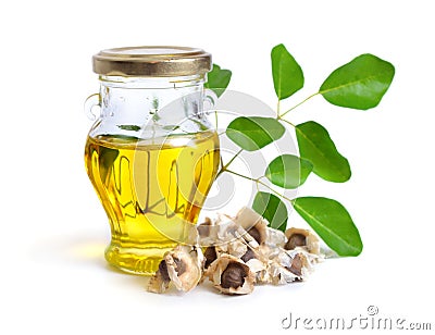 Moringa oleifera oil with seeds and leawes. Isolated on white ba Stock Photo