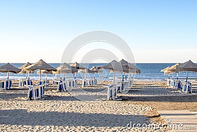 Morning beach Malaga Spain blue sea and beach umbrellas Stock Photo
