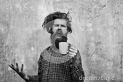 Morning coffe. singing bearded man pulling stylish fringe hair with blue cup Stock Photo