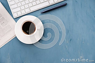 Morning coffee and fresh newspaper on the blue desk top Editorial Stock Photo