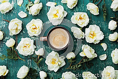 Morning cup of coffee and beautiful roses flowers on teal vintage background top view. Cozy Breakfast. Flat lay style. Stock Photo