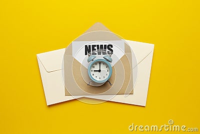 Morning e-mail newsletter. Envelopes and clock on yellow background Stock Photo