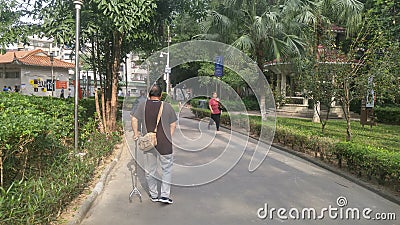 Shenzhen, China: elderly men walk for physical rehabilitation training Editorial Stock Photo