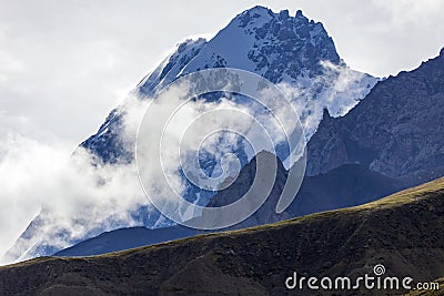 Morning fog and gusty wind in the rocky relief mountains Stock Photo
