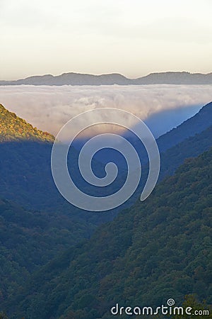 Morning fog at sunrise in autumn mountains of West Virginia in Babcock State Park Stock Photo