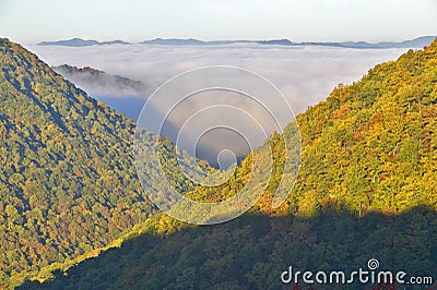 Morning fog at sunrise in autumn mountains of West Virginia in Babcock State Park Stock Photo