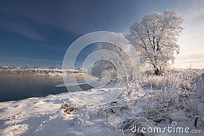 Morning Frosty Winter Landscape With Dazzling White Snow And Hoarfrost, River And A Saturated Blue Sky.Winter Small River On A Sun Stock Photo