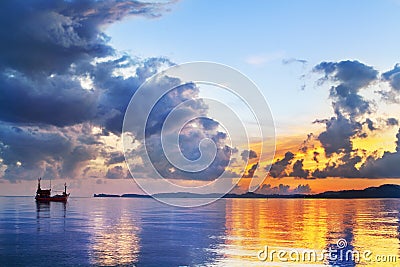 Morning golden sunrise on blue sea, ship silhouette and clouds scenic landscape, scenery ocean bright colorful sunset, Thailand Stock Photo