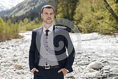 Morning of the groom. Groom morning preparation. Young and handsome groom getting dressed in a wedding shirt Stock Photo