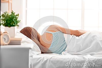 Morning at Home. Woman lying on bed sleeping back view Stock Photo