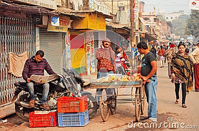 Morning of indian city with farm traders and man reading newspaper Editorial Stock Photo