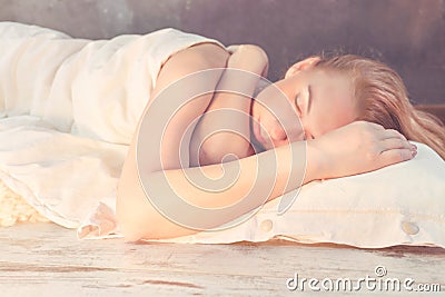 Morning light illuminates woman sleeping in bed Stock Photo