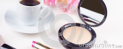 Panoramic mocap with a cup of coffee, powder and lipstick, feminine morning background Stock Photo