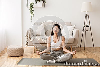 Morning Meditation. Asian Girl Practicing Yoga at Home Stock Photo