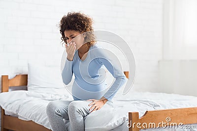 African-american expectant woman feeling nauseous, covering mouth Stock Photo