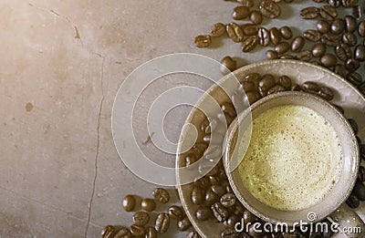 Morning sun light. Cappuccino or latte coffee cup with coffee beans, Stock Photo