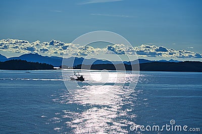 The morning sunlight mapped the surface of the lake. The work boat is operating. Editorial Stock Photo