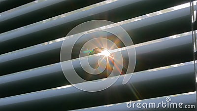 Sun lens flare through window louvers Stock Photo