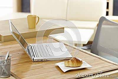 Morning table with laptop and breakfast Stock Photo