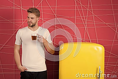 Morning teas to jump start your day. Man inspired smile with morning drink near refrigerator. Bachelor hold cup of tea Stock Photo