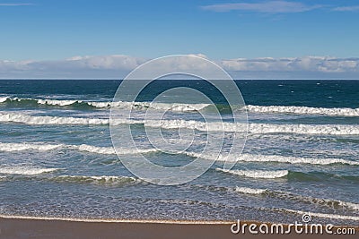 Morning view of the beach with breaking waves crashing sand on s Stock Photo