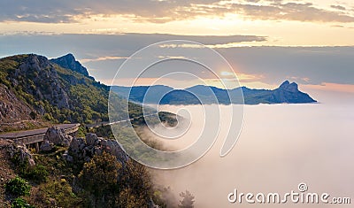 Morning view of coastline in mist (like cloudy sea) and highway (Foros Town environs, Crimea, Ukraine Stock Photo