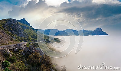 Morning view of coastline in mist (like cloudy sea) and highway (Foros Town environs, Crimea, Ukraine Stock Photo