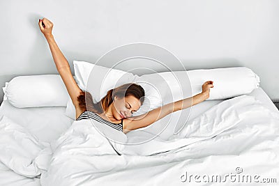 Morning Wake Up. Woman Waking Stretching In Bed. Healthy Lifestyle Stock Photo