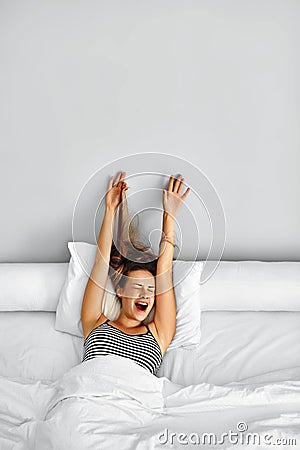 Morning Wake Up. Woman Waking Stretching In Bed. Healthy Lifestyle Stock Photo