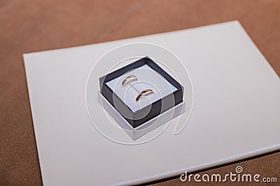 Morning of the wedding day. A pair of golden rings in the box. Happy wedding day. Copy space Stock Photo