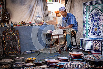 Moroccan artisan working with his hands in his workshop Editorial Stock Photo