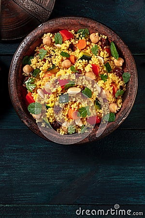 Moroccan couscous closeup in a tagine, shot from above with a place for text Stock Photo