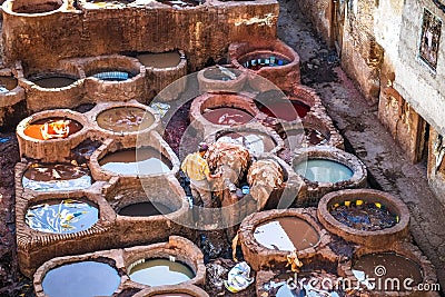A Moroccan man working with animal hides in the leather tannery. Fez, Morocco Editorial Stock Photo