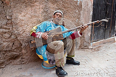 Moroccan musician playing guitar from Morocco, gumbri, guembri or hajhouj, Marrkech Editorial Stock Photo