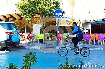 Moroccan riding a bicycle next to the souk Editorial Stock Photo