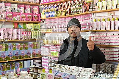 Moroccan shop owner selling body care products Editorial Stock Photo