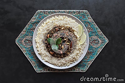 Moroccan spiced mince with couscous on a black. Stock Photo