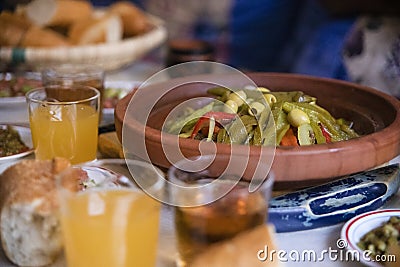 Moroccan Tajine of meat that is the typical dish of Morocco and is usually accompanied with olives and drinks like juice and tea Stock Photo