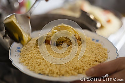 Moroccan traditional couscous plate dishing up. Stock Photo