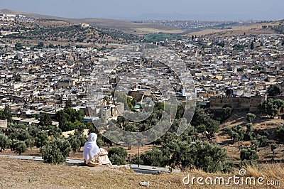 Moroccan woman in golden djellaba and white hijab Stock Photo