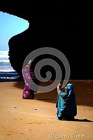 Morocco, beach Legzira - September 17: Local woman posing in bright clothes on the beach. Editorial Stock Photo