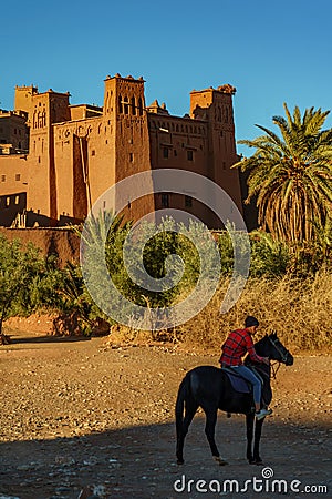 Morocco. Horse rider in front of the village of Ait Ben haddou Editorial Stock Photo