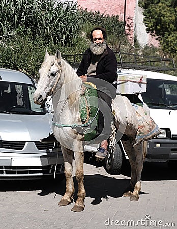 Morocco, the market square of the city of Fez. March 12 2019. Horseman riding a bazaar Editorial Stock Photo