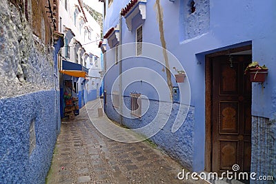 Blue house, old window and brick eaves in Morocco Editorial Stock Photo